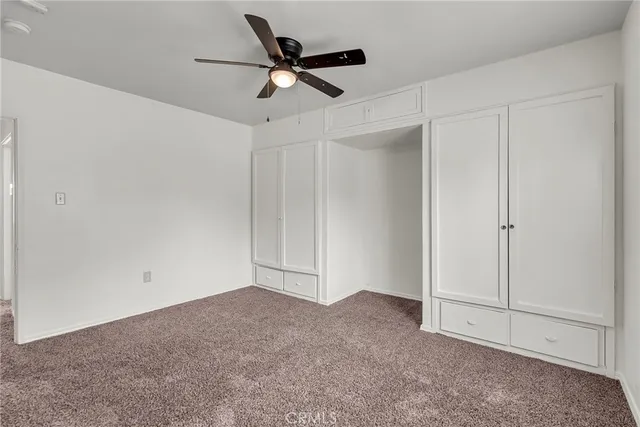 a view of a livingroom with a ceiling fan and window