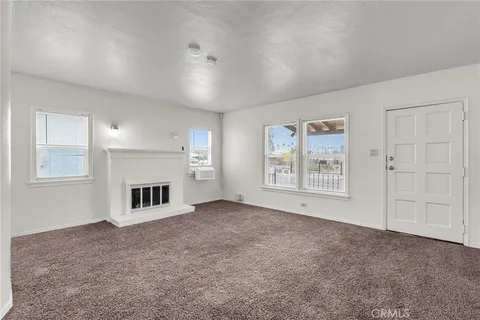 a view of empty room with a fireplace