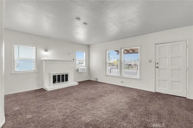 a view of empty room with a fireplace