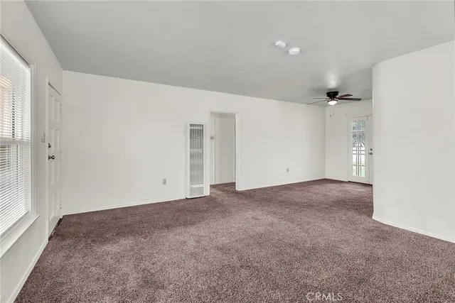 a view of a big room with closet and windows