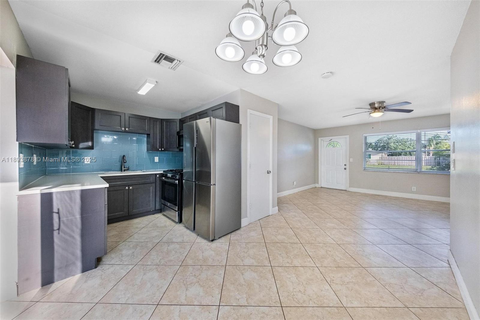 3589 Island Road Palm Beach Gardens, FL 33410 - Photo 13 of 40 a kitchen with a refrigerator a stove top oven and a refrigerator