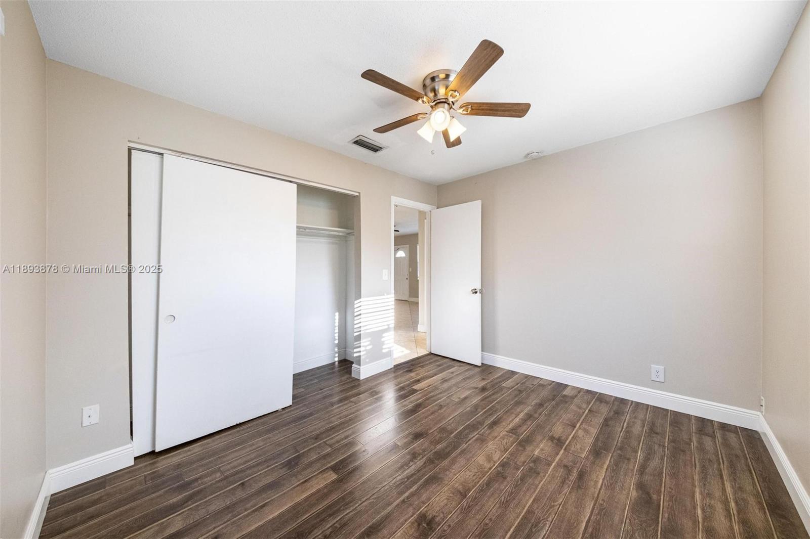 3589 Island Road Palm Beach Gardens, FL 33410 - Photo 15 of 40 a view of a big room with wooden floor and windows in a room