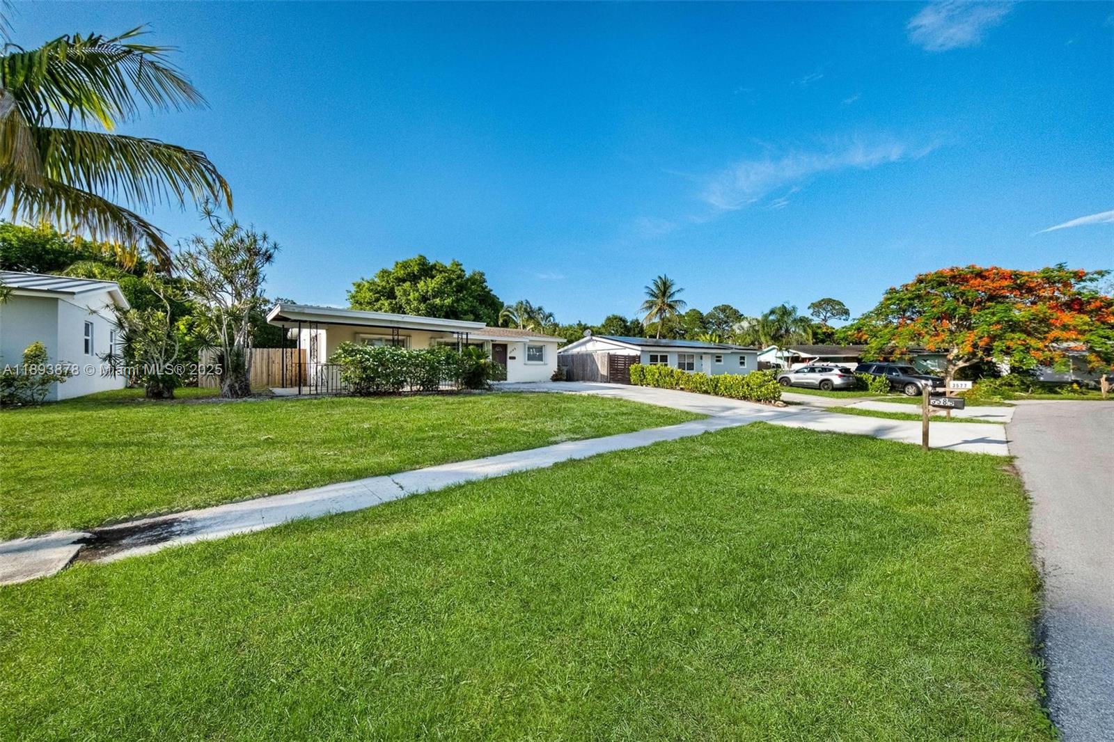 3589 Island Road Palm Beach Gardens, FL 33410 - Photo 2 of 40 a view of yard with swimming pool and green space