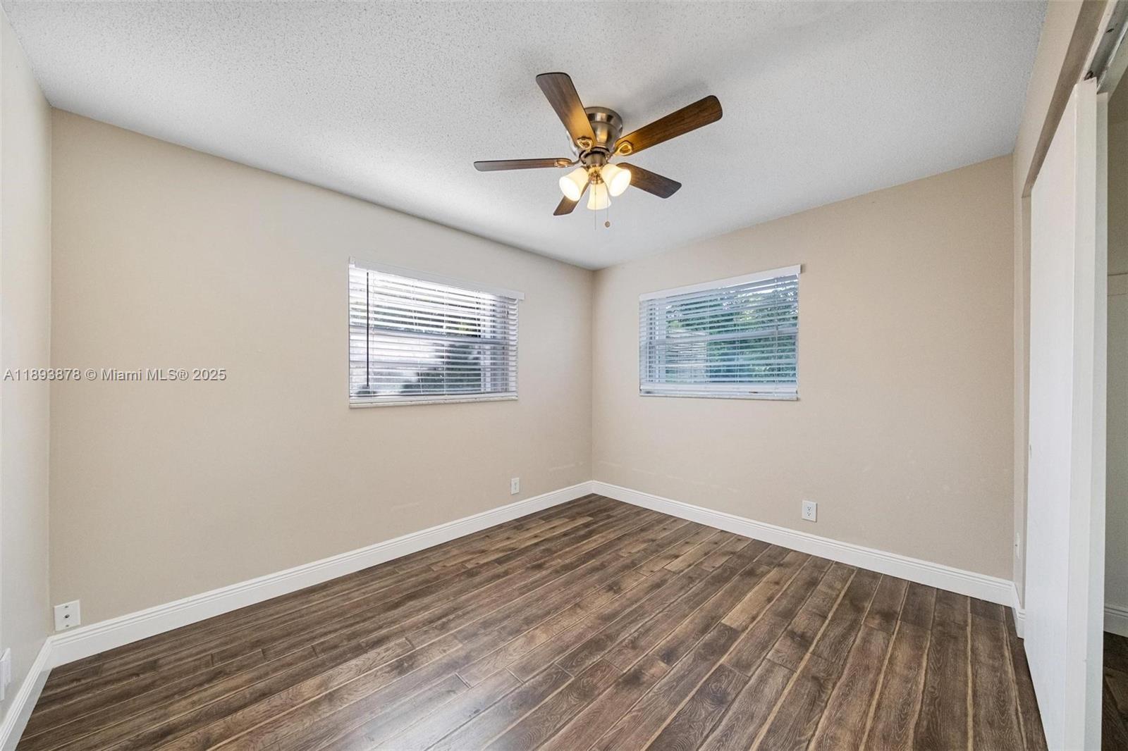 3589 Island Road Palm Beach Gardens, FL 33410 - Photo 28 of 40 a view of a big room with wooden floor closet and windows