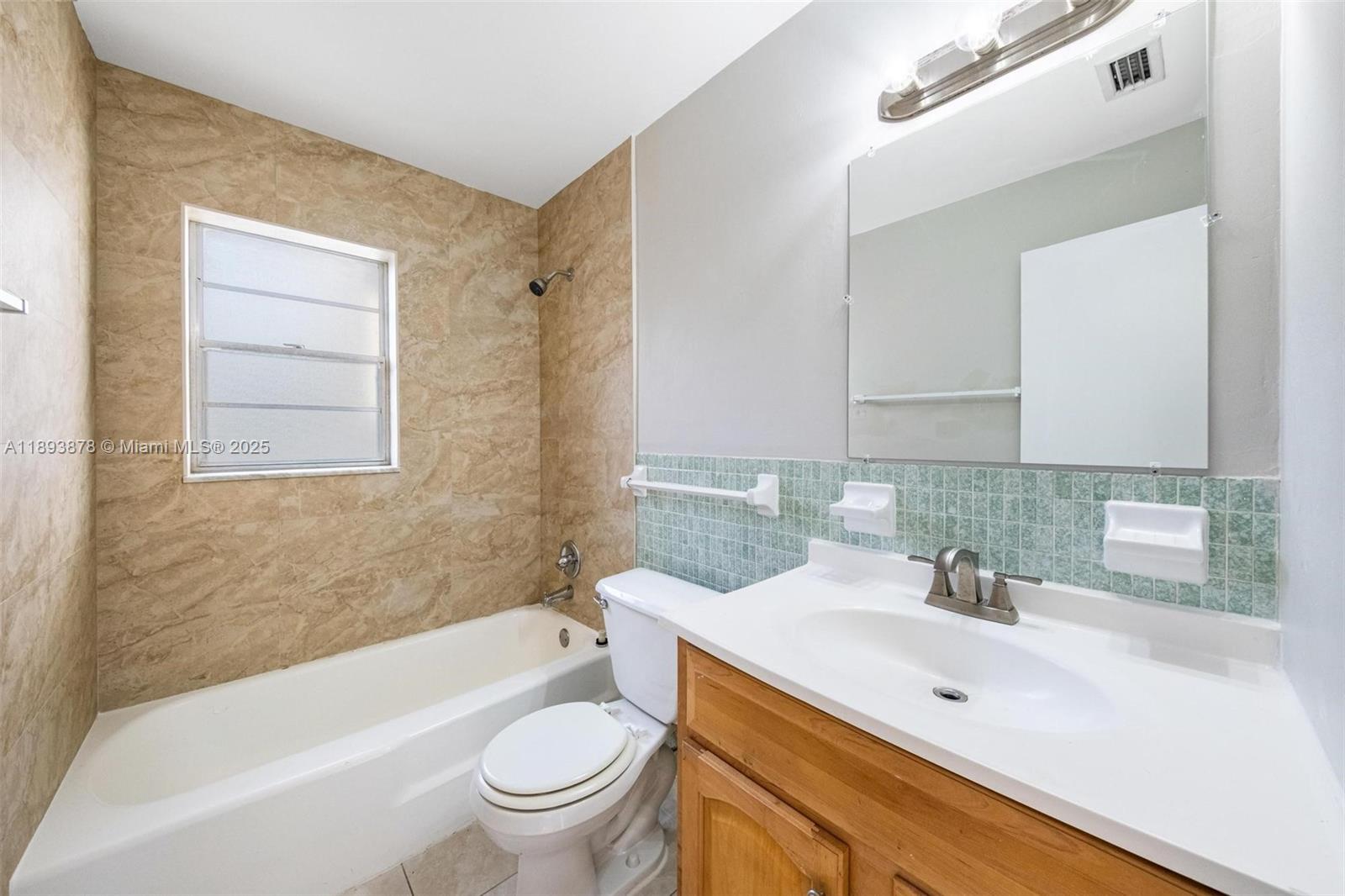 3589 Island Road Palm Beach Gardens, FL 33410 - Photo 30 of 40 a bathroom with a sink a toilet and a bathtub