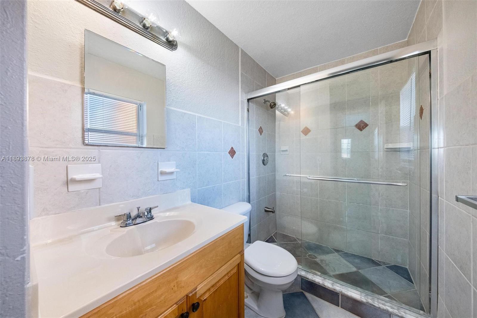 3589 Island Road Palm Beach Gardens, FL 33410 - Photo 31 of 40 a bathroom with a sink toilet and shower