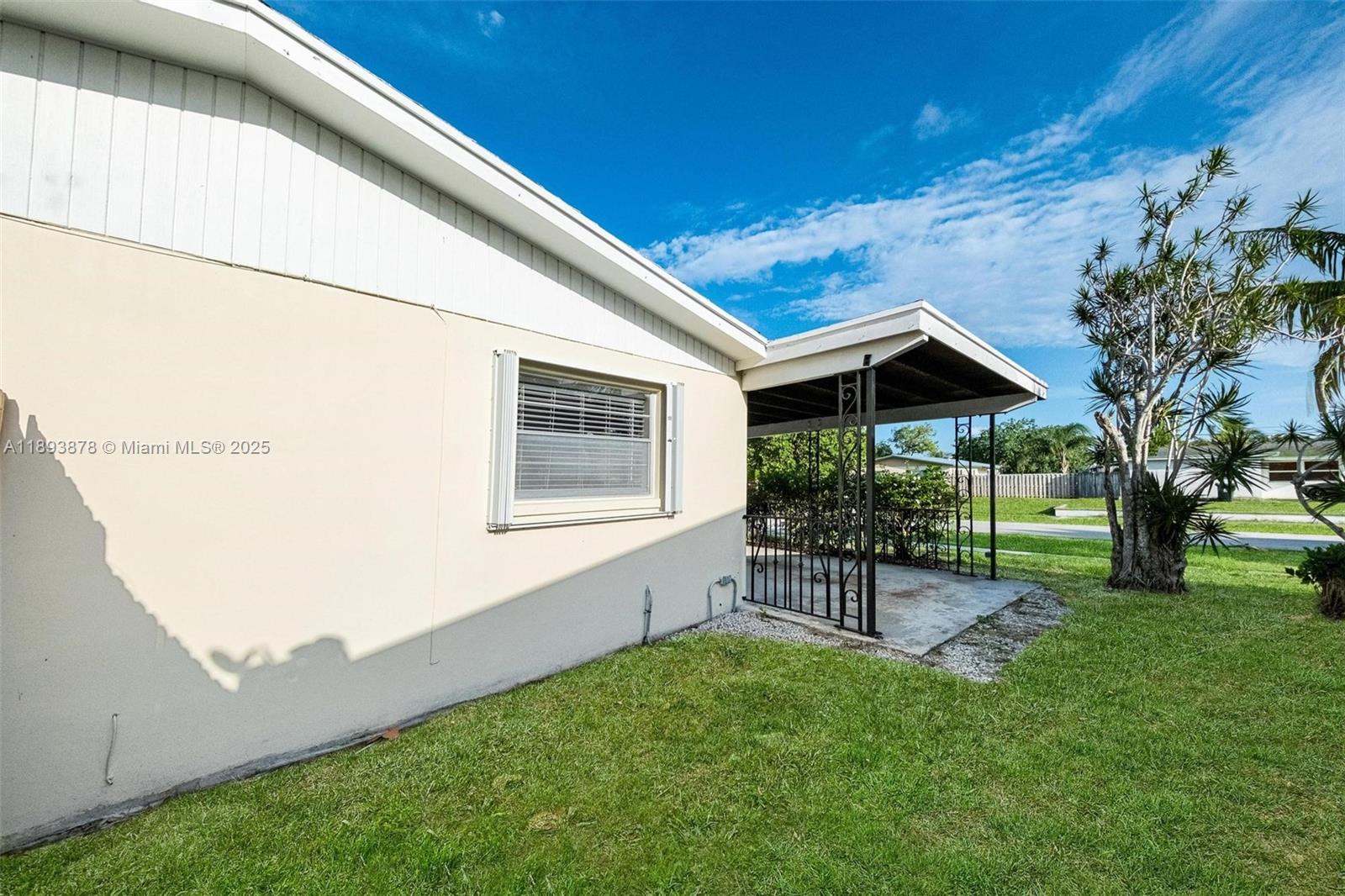 3589 Island Road Palm Beach Gardens, FL 33410 - Photo 32 of 40 a view of house with backyard and a garden