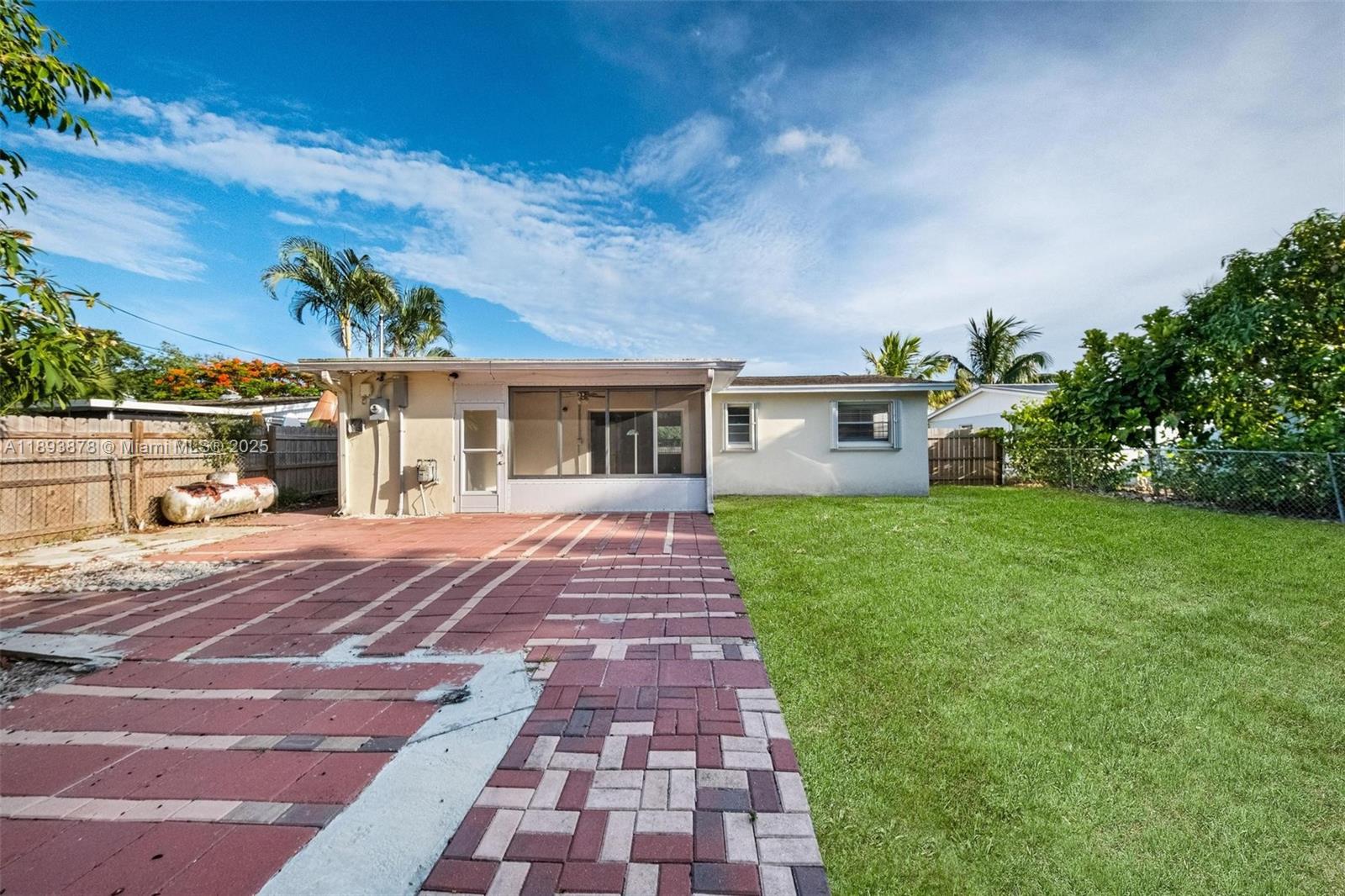 3589 Island Road Palm Beach Gardens, FL 33410 - Photo 36 of 40 a front view of a house with a yard and potted plants