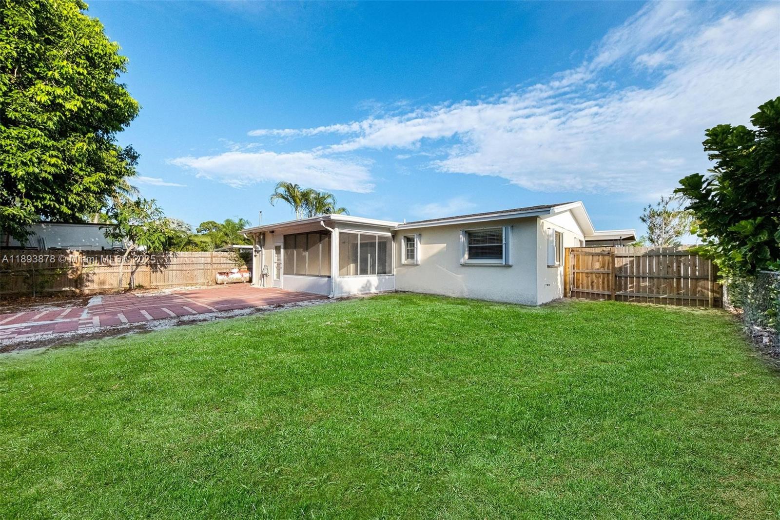 3589 Island Road Palm Beach Gardens, FL 33410 - Photo 39 of 40 a view of a house with backyard and garden