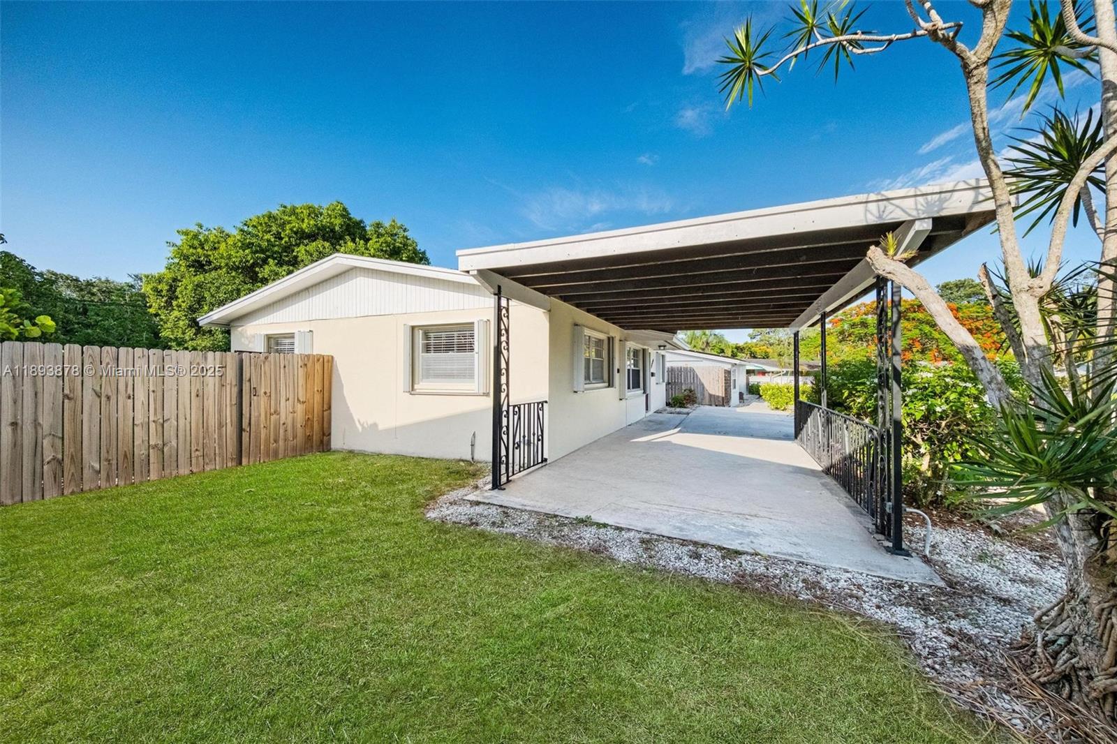 3589 Island Road Palm Beach Gardens, FL 33410 - Photo 9 of 40 a view of a house with a yard
