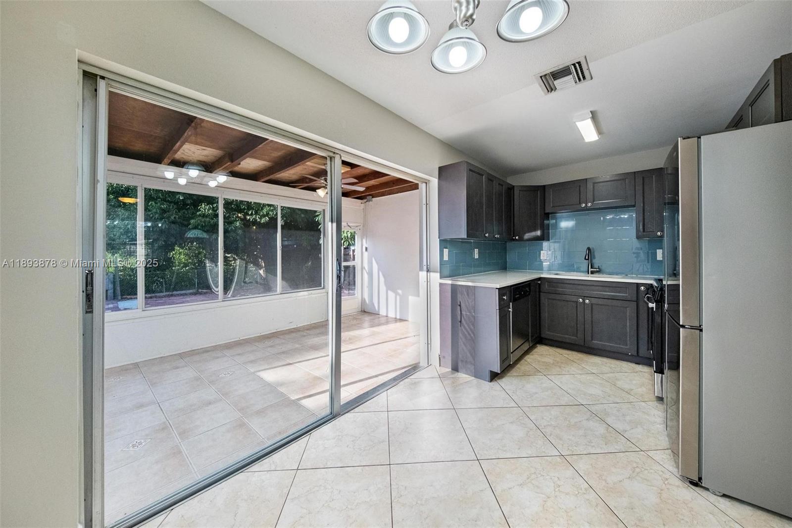 3589 Island Road Palm Beach Gardens, FL 33410 - Photo 10 of 40 a kitchen with stainless steel appliances granite countertop a refrigerator and a sink