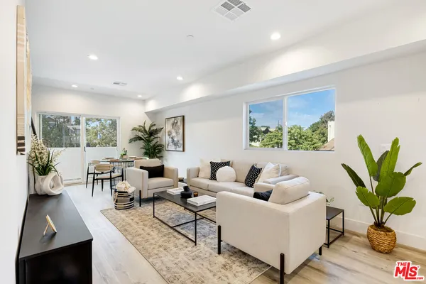 a living room with furniture and a potted plant