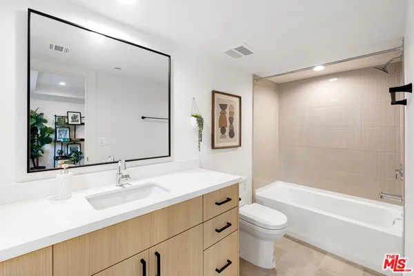 a bedroom with a bed and a night stand