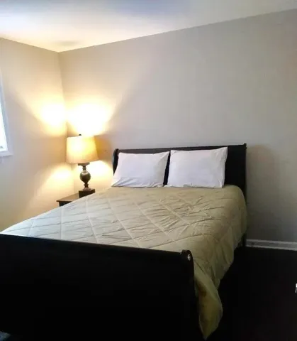 a bedroom with a bed and a lamp