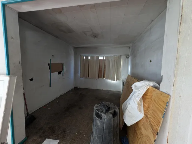 a lobby with furniture and chandelier