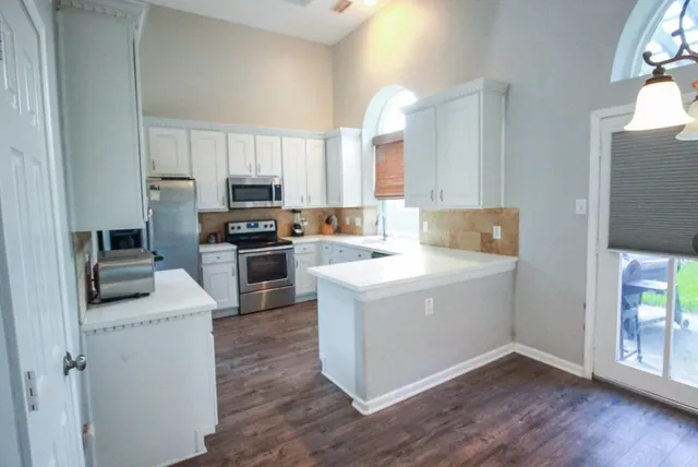 a view of kitchen with sink and wooden floor