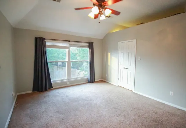 a view of a livingroom with a ceiling fan and window