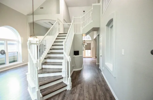 a view of entryway and hall with wooden floor
