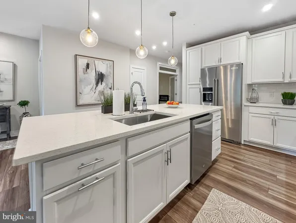 a kitchen with stainless steel appliances granite countertop white cabinets and stove