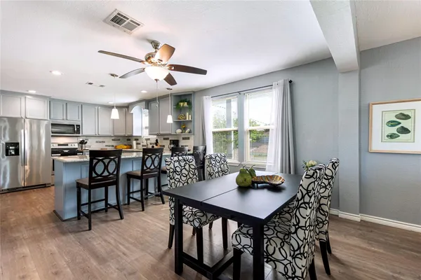 a view of a dining room with furniture and wooden floor