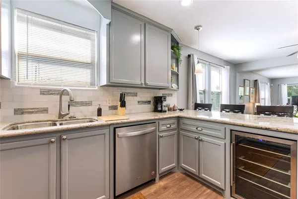 a kitchen with a sink stove and cabinets