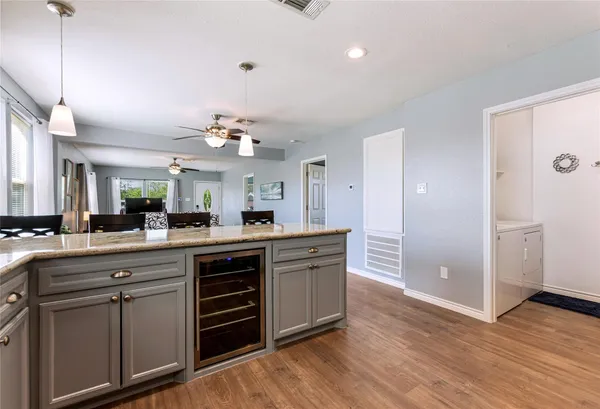 a kitchen with stainless steel appliances a sink cabinets and wooden floor