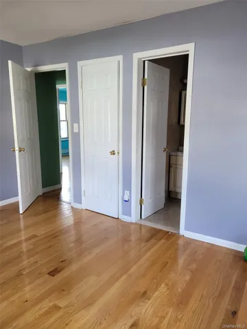 a view of a room with wooden floor and closet
