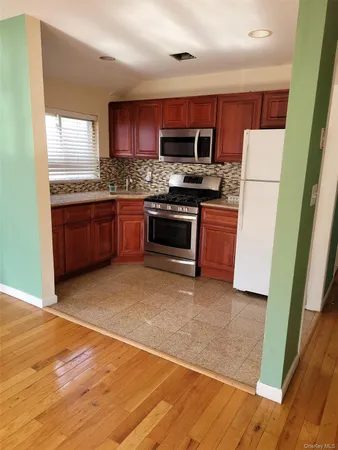 a kitchen with stainless steel appliances granite countertop a refrigerator stove a sink and dishwasher
