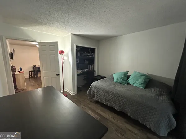 a spacious bedroom with a bed and a table in it