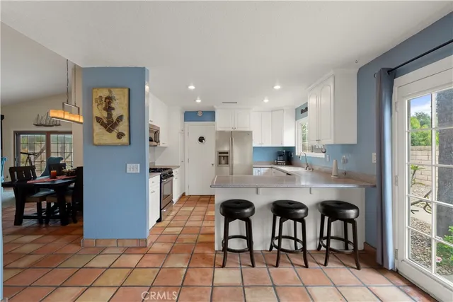 a kitchen with stainless steel appliances granite countertop a refrigerator sink and cabinets