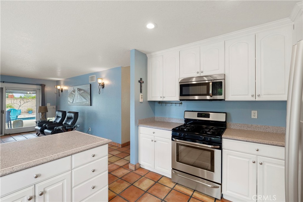 2537 Fulton Road La Verne, CA 91750 - Photo 19 of 43 a kitchen with white cabinets and appliances