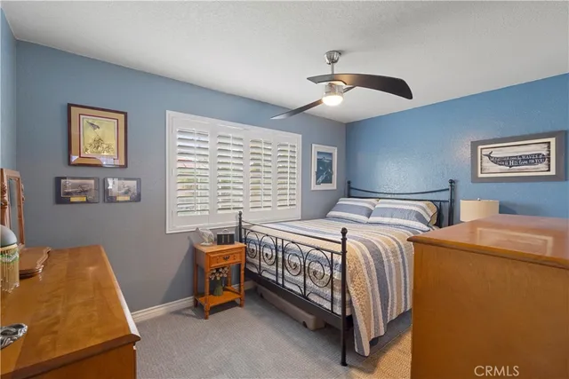 a bedroom with a large bed and a dresser