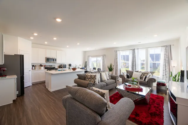 a living room with furniture and kitchen view