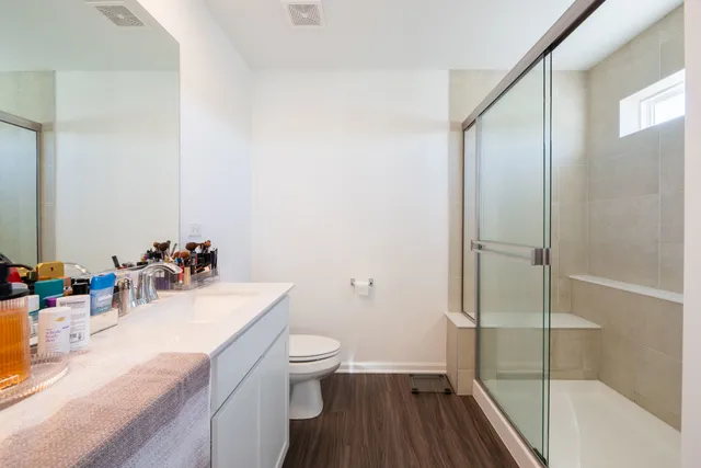 a bathroom with a sink mirror toilet and shower