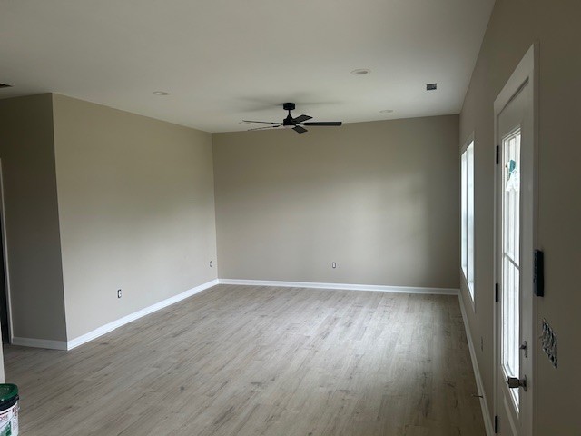 402 North 3rd Street Pulaski, TN 38478 - Photo 3 of 8 an empty room with wooden floor and windows