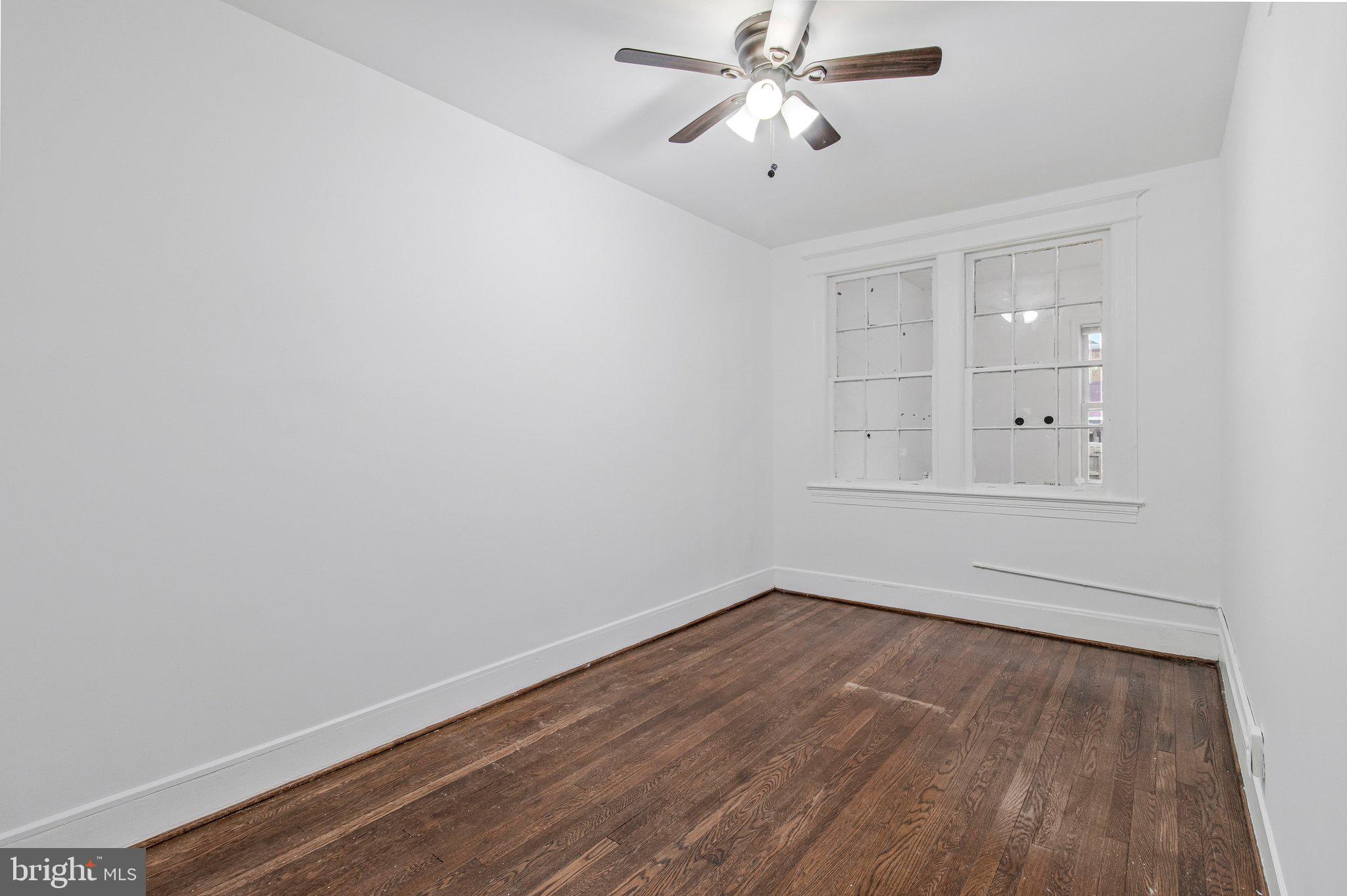 1719 West Virginia Avenue Northeast, Unit 1 Washington, DC 20002 - Photo 17 of 24 an empty room with wooden floor and windows
