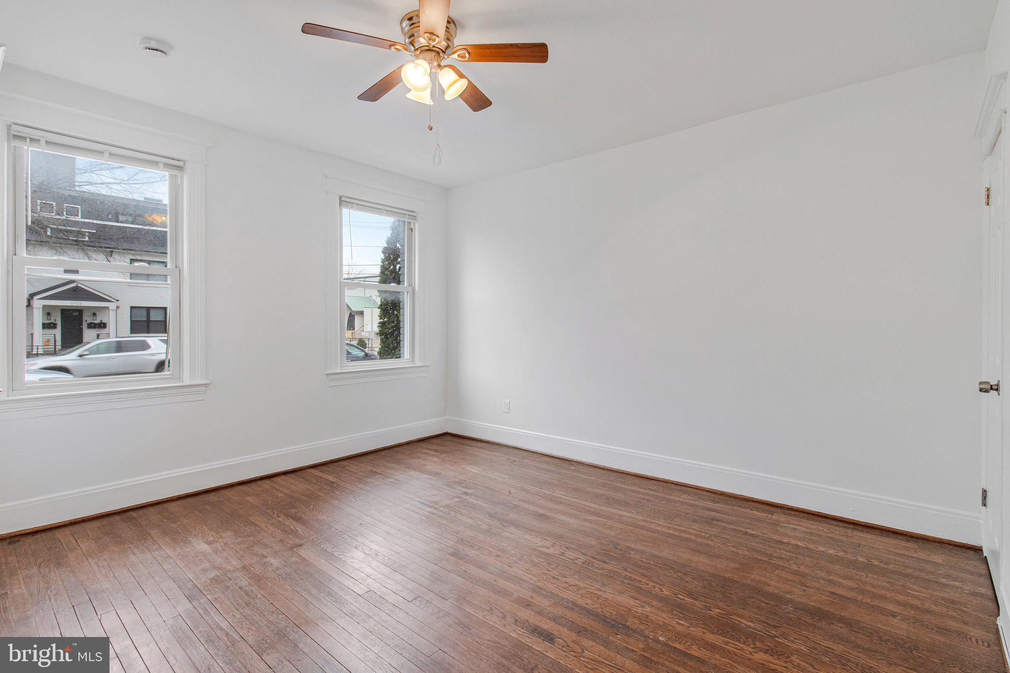 1719 West Virginia Avenue Northeast, Unit 1 Washington, DC 20002 - Photo 4 of 24 a view of an empty room with wooden floor and a window