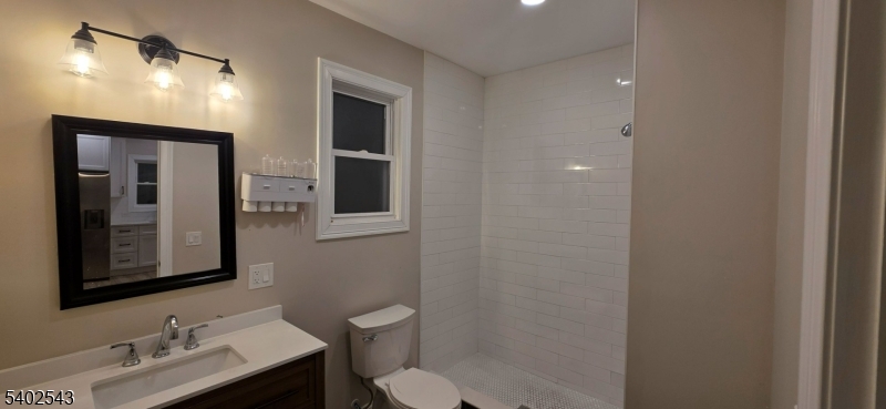 115 Wallington Avenue Wallington, NJ 07057 - Photo 13 of 13 a bathroom with a toilet sink and mirror