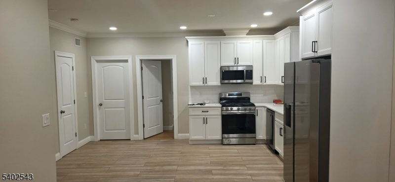 115 Wallington Avenue Wallington, NJ 07057 - Photo 2 of 13 a kitchen with stainless steel appliances granite countertop a refrigerator stove and sink