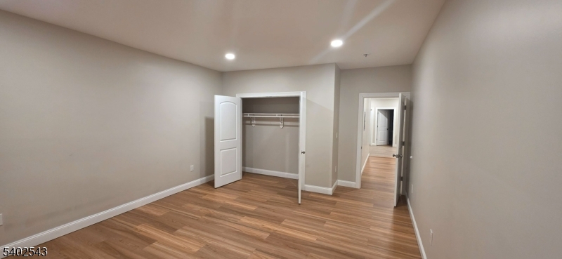 115 Wallington Avenue Wallington, NJ 07057 - Photo 5 of 13 a view of empty room with wooden floor