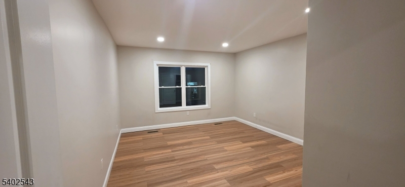 115 Wallington Avenue Wallington, NJ 07057 - Photo 6 of 13 a view of an empty room with a window