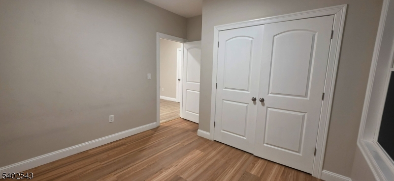 115 Wallington Avenue Wallington, NJ 07057 - Photo 9 of 13 a view of empty room with wooden floor