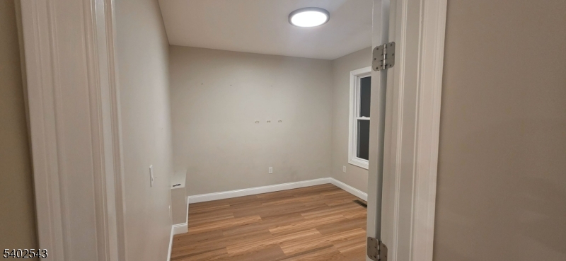 115 Wallington Avenue Wallington, NJ 07057 - Photo 10 of 13 a view of a hallway with wooden floor