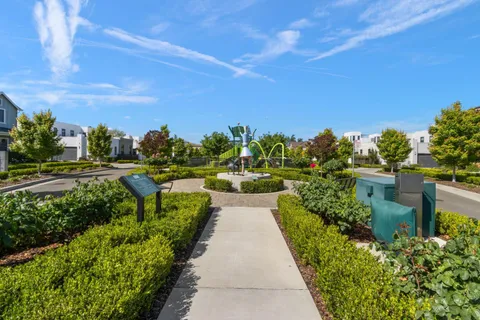 a view of yard with swimming pool and trees in the background