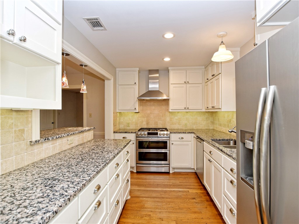 3103 Glenview Avenue Austin, TX 78703 - Photo 1 of 1 a kitchen with stainless steel appliances granite countertop a stove and a sink