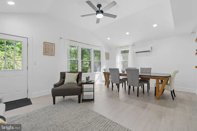 a living room with furniture and a large window with outer view