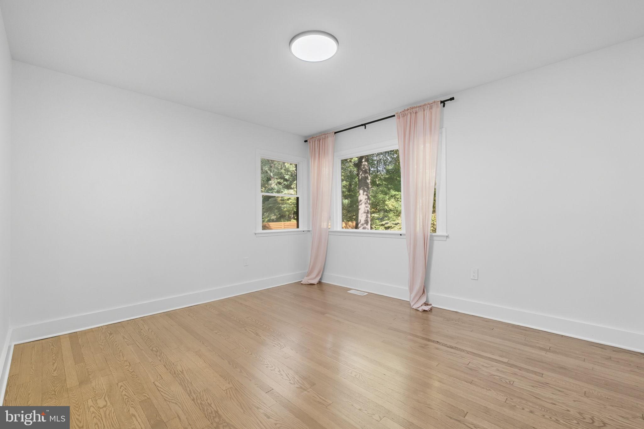 2539 Gallows Road Dunn Loring, VA 22027 - Photo 23 of 43 an empty room with wooden floor and windows
