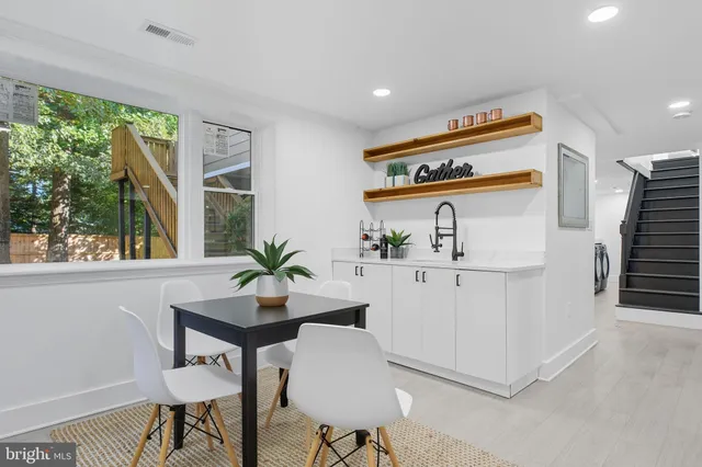 a living room with furniture potted plant and windows