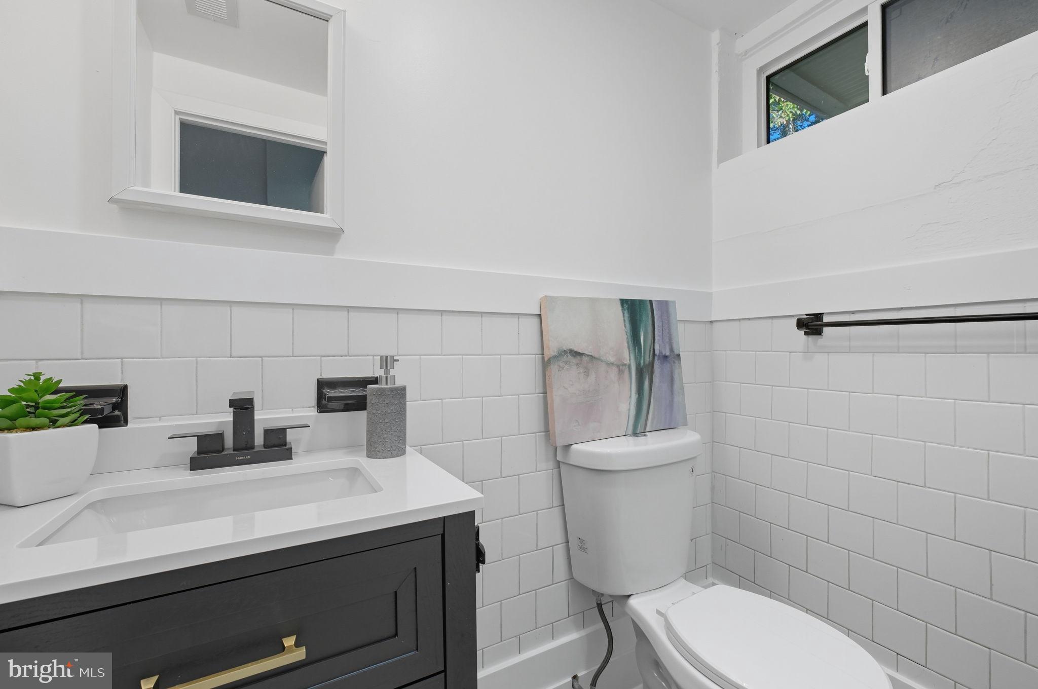 2539 Gallows Road Dunn Loring, VA 22027 - Photo 37 of 43 a bathroom with a sink a toilet and shower