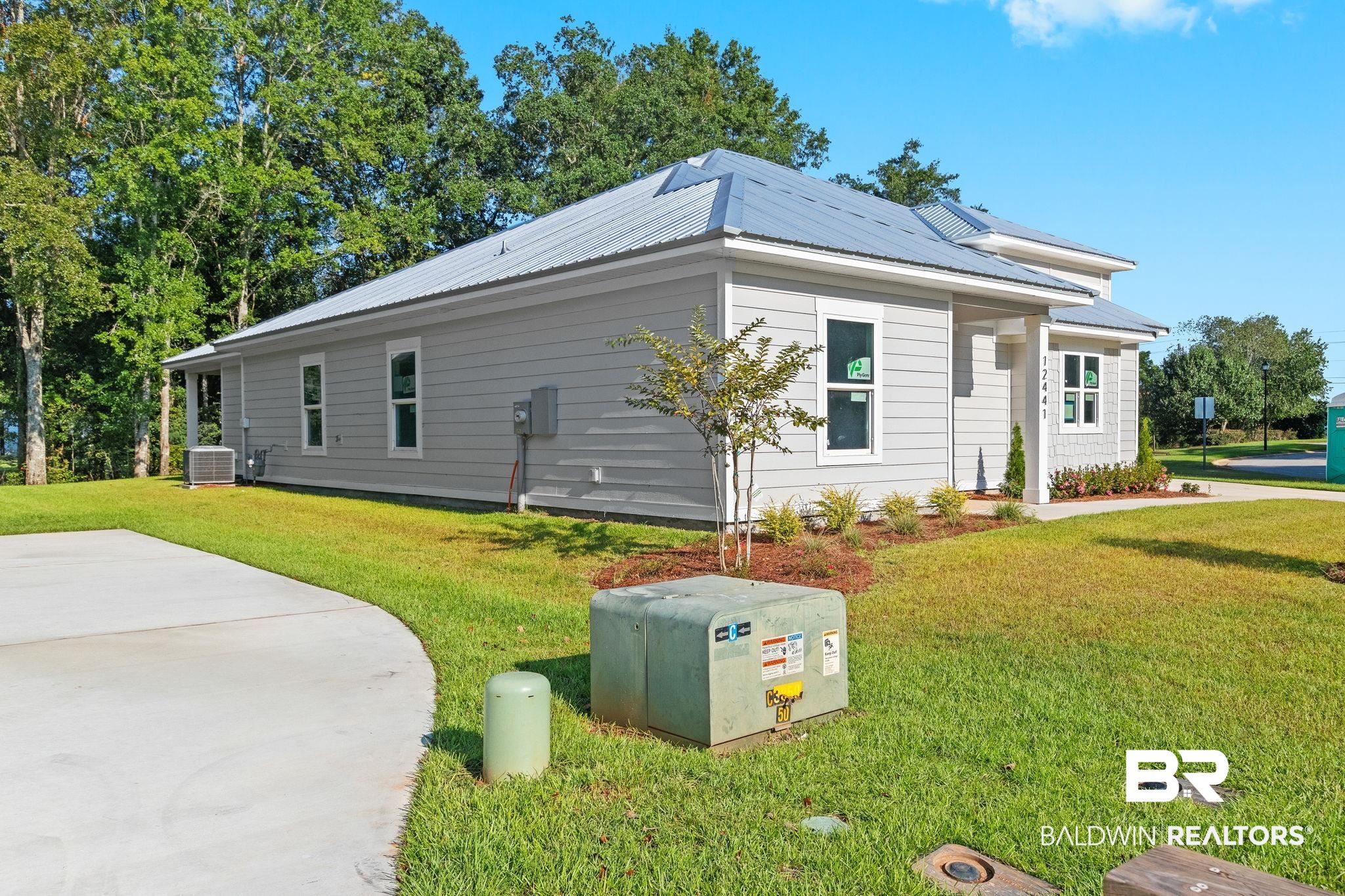 12441 Reunion Place Foley, AL 36535 - Photo 2 of 31 View of side of property with central AC unit and a lawn